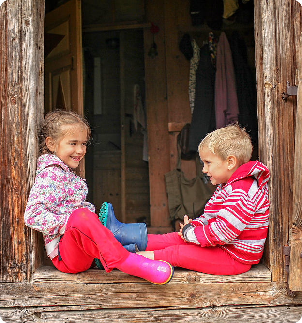 Children sitting on a wooden porch